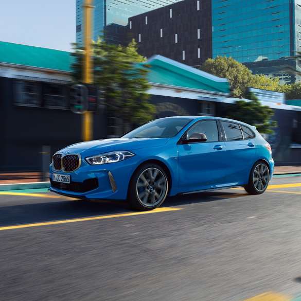 BMW 1 Series, three-quarter side view. BMW 1 Series in Misano Blue metallic, three-quarter front view driving.